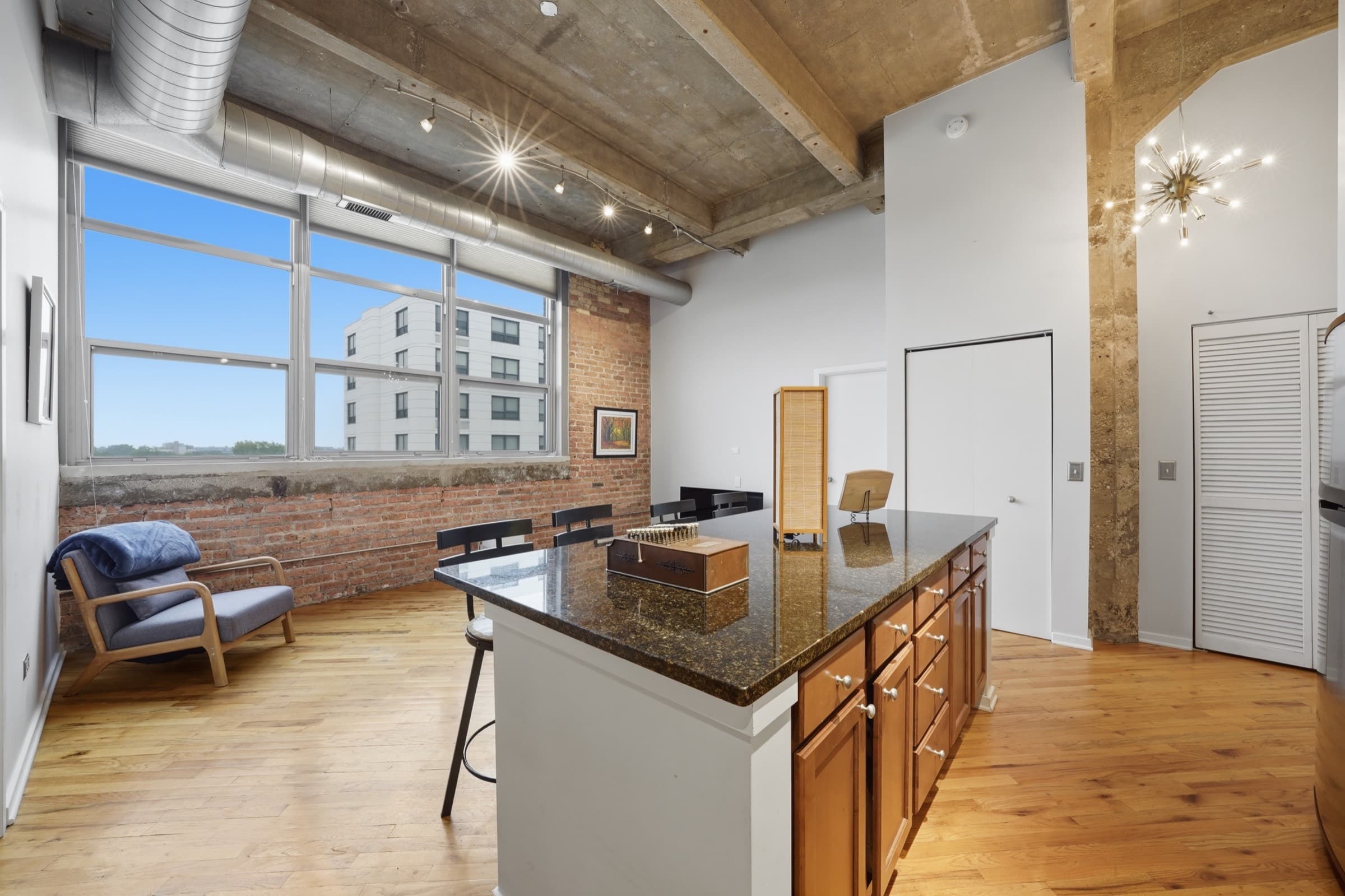 The main room from the windows, with the island and the sputnik fixture