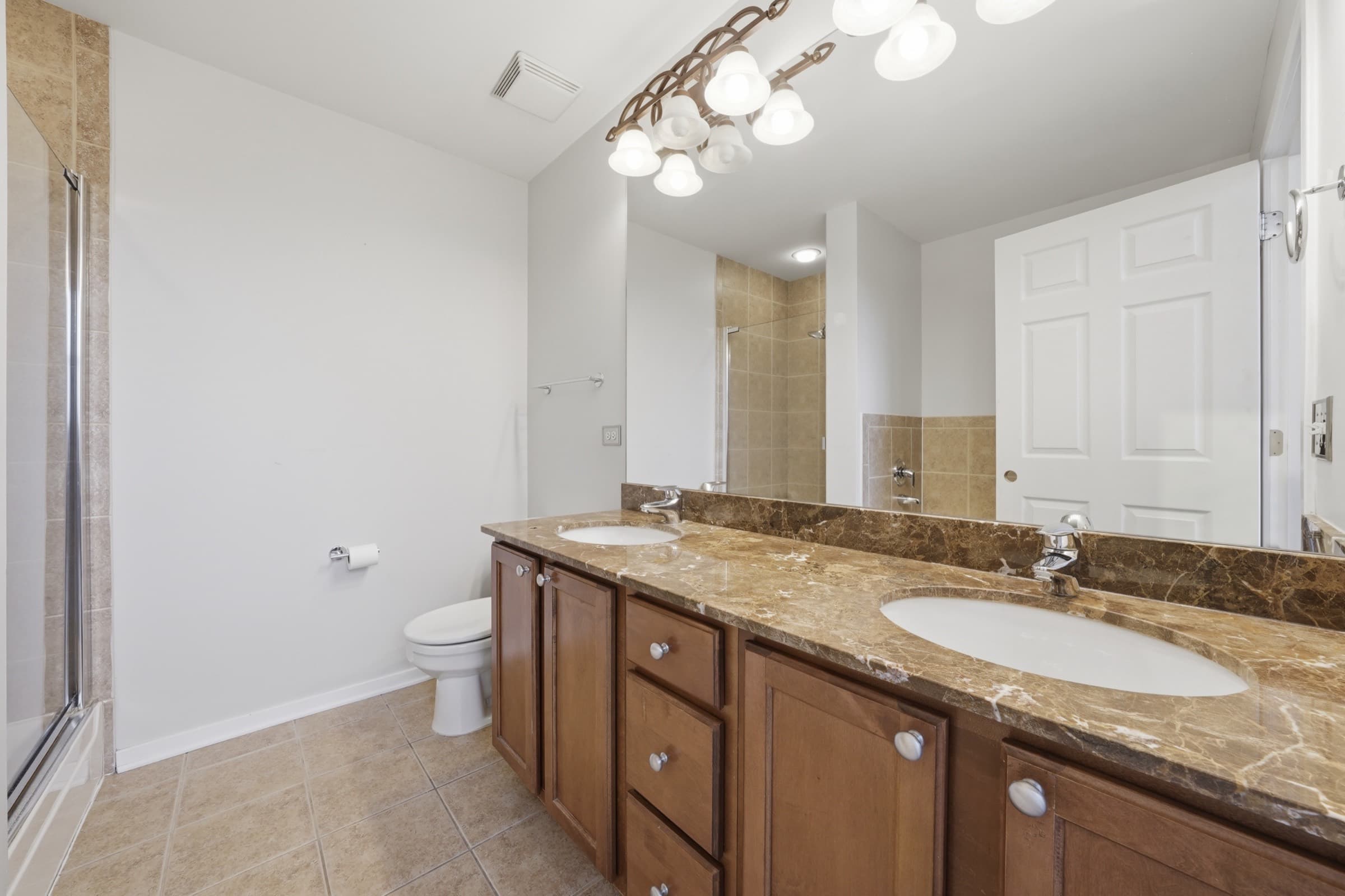 Primary bath with a double vanity and glass shower